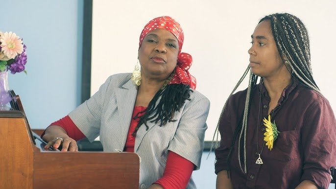 Voice teacher, Sherry Wilson Butler sitting on piano with student